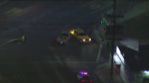 A truck being pursued by Huntington Park police on Feb. 20, 2018, slams into a yellow cab in Boyle Heights while being chased. (Credit: KTLA)