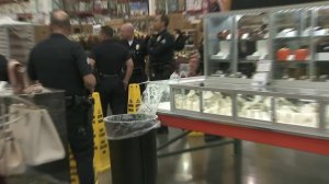 Officers investigate a scene after three men reportedly robbed a Costco in Pacoima on Feb. 12, 2018. (Credit: KTLA)