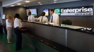 In this file photo, customer service representatives wait on customers at Enterprise rent-a-car at the Fort Lauderdale/Hollywood International airport July 10, 2007 in Fort Lauderdale, Florida. (Credit: Joe Raedle/Getty Images)