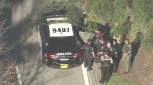 A male was seen being taken into police custody after a school shooting in Parkland, Florida, on Feb. 14, 2018. (Credit: WSVN)