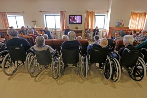 Elderly people watch TV in the living room of nursing home in Alpiarca, Portugal, on Jan. 10, 2016. (Credit: Jose Manuel Ribeiro / AFP / Getty Images)