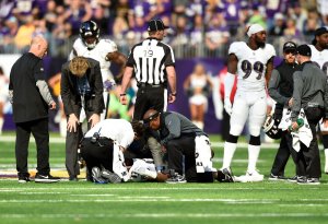 Mike Wallace of the Baltimore Ravens lies on the field while being assessed by medical staff during a game on Oct. 22, 2017 at U.S. Bank Stadium in Minneapolis, Minnesota. (Credit: Hannah Foslien/Getty Images)