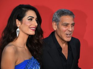 George Clooney and his wife Amal Clooney arrive for the Premiere of Paramount Pictures 'Suburbicon' at the Regency Village Theatre in Westwood, on October 22, 2017. (Credit: MARK RALSTON/AFP/Getty Images)