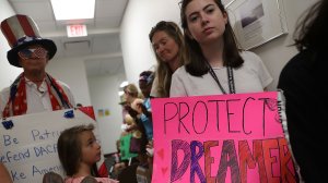 Lily Logsdon, right, joins other activists in front of the office of Sen. Bill Nelson, D-FL, to ask him to help recipients of the Deferred Action for Childhood Arrivals on Feb. 2, 2018 in West Palm Beach, Florida. (Credit: Joe Raedle/Getty Images)