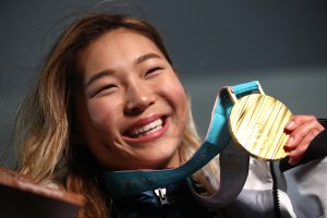 Gold medalist Chloe Kim of the United States poses during the medal ceremony for the snowboard ladies' halfpipe final in the PyeongChang 2018 Winter Olympic Games on Feb. 13, 2018. (Credit: Alexander Hassenstein / Getty Images)