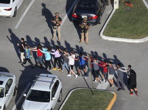 People are brought out of the Marjory Stoneman Douglas High School in Parkland, Florida after a shooting was reported at the campus on Feb. 14, 2018. (Credit: Joe Raedle/Getty Images)