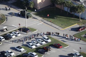 People are brought out of Marjory Stoneman Douglas High School after a shooting at the school on Feb. 14, 2018, in Parkland, Florida. (Credit: Joe Raedle/Getty Images)