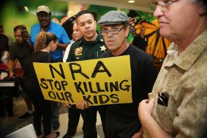 A protester holds a sign that reads "NRA Stop Killing Our Kids" outside Broward County Courthouse, where Nikolas Cruz was having a bond hearing on Feb. 15, 2018 in Fort Lauderdale, Florida. (Credit: Charles Trainor Jr. - Pool/Getty Images)