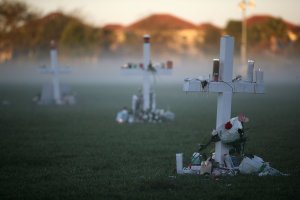 Candles that were placed on crosses still glow after a vigil the previous night for victims of the mass shooting at a high school in Parkland, Florida, Feb. 16, 2018. (Credit: Mark Wilson/Getty Images)