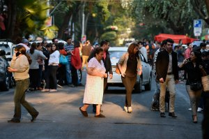People flood the streets after a powerful earthquake jolted Mexico City on Feb. 16, 2018. (Credit: Alfredo Estrella / AFP / Getty Images)