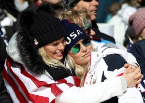 Lindsey Vonn of the United States, at right, is consoled at the finish during the Alpine Skiing Ladies Super-G at the PyeongChang 2018 Winter Olympics on Feb. 17, 2018. (Credit: Clive Mason / Getty Images)