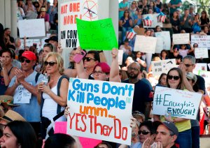 Protesters hold signs at a rally for gun control at the Broward County Federal Courthouse in Fort Lauderdale, Florida, on Feb. 17, 2018. (Credit: Rhona Wise / AFP / Getty Images)