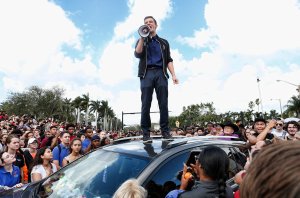 Cameron Kasky addresses area students as they rally at Marjory Stoneman Douglas High School after participating in a countywide school walk-out in Parkland, Florida, on Feb. 21, 2018. (Credit: Rhona Wise / AFP / Getty Images)