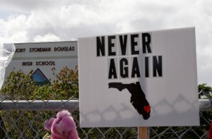 Memorials are seen on a fence surrounding Marjory Stoneman Douglas High School in Parkland, Florida, on Feb. 21, 2018. (Credit: RHONA WISE/AFP/Getty Images)