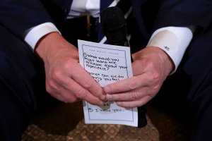 President Donald Trump holds his notes while hosting a listening session with students survivors of mass shootings, their parents and teachers in the State Dining Room at the White House on Feb. 21, 2018. (Credit: Chip Somodevilla / Getty Images)