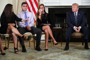 President Donald Trump hosts a listening session with Marjory Stoneman Douglas High School shooting survivors Julie Cordover, second from right, Jonathan Blank and his mother Melissa Blank in the State Dining Room at the White House on Feb. 21, 2018. (Credit: Chip Somodevilla / Getty Images)