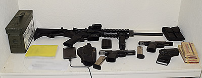 Guns and ammunition allegedly found in Jacob McBain's home are shown in a photo released by the Riverside County Sheriff's Department on Feb. 20, 2018.