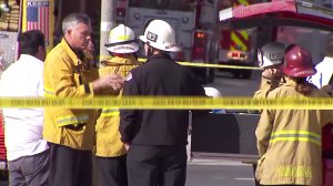 Firefighters and other first responders stand at the scene at Cal State Long Beach, where a chemistry experiment sparked a fire that injured one person on Feb. 27, 2018. (Credit: KTLA)