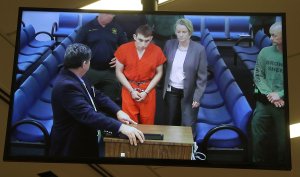Nikolas Cruz, 19, a former student at Marjory Stoneman Douglas High School in Parkland, Florida, where he allegedly killed 17 people, is seen on a closed circuit television screen during a bond hearing in front of Broward Judge Kim Mollica at the Broward County Courthouse on Feb. 15, 2018, in Fort Lauderdale, Florida. (Credit: Susan Stocker - Pool/Getty Images)