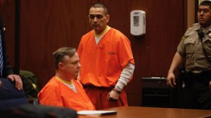 Los Angeles police officers James C. Nichols (seated) and Luis Valenzuela entered their no-contest pleas to sexually assaulting multiple women in a downtown Los Angeles courtroom. (Credit: Gary Coronado / Los Angeles Times)
