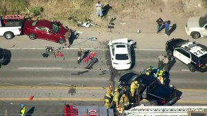 Authorities and onlookers respond to the scene of a multivehicle crash in the 20100 block of Pacific Coast Highway on Feb. 7, 2018. (Credit: KTLA)