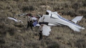 L.A. County sheriff's deputies inspect the site where a small aircraft crashed Sunday, killing four people in a remote area near Agua Dulce. (Credit: Robert Gauthier / Los Angeles Times)