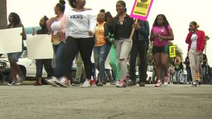 Protestors march in an area of South Los Angeles near where 16-year-old Anthony Weber was shot dead by an L.A. County sheriff's deputy nearly a week earlier, demanding answers in the teen's death. (Credit: KTLA)