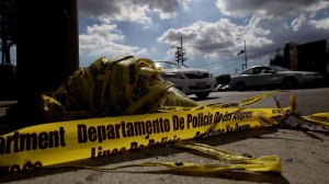 The scene in Van Nuys near the intersection where two LAPD officers shot and killed James Byrd after, authorities say, he threw a beer bottle through one of the windows of their police car is seen littered with police tape here. (Credit: Luis Sinco / Los Angeles Times)