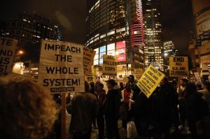 Protesters rally at 7th and Figueroa streets waiting for the arrival of President Trump to the InterContinental Los Angeles Downtown Hotel on March 13, 2018. (Credit: Genaro Molina / Los Angeles Times)