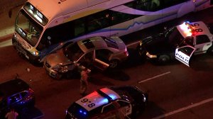 A car is seen smashed against a bus in the City of Industry following a pursuit on March 27, 2018. (Credit: KTLA)