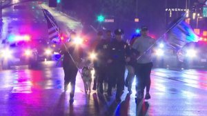 LAPD officer Joe Cirrito runs in downtown Los Angeles on March 10, 2018. (Credit: ANG News)