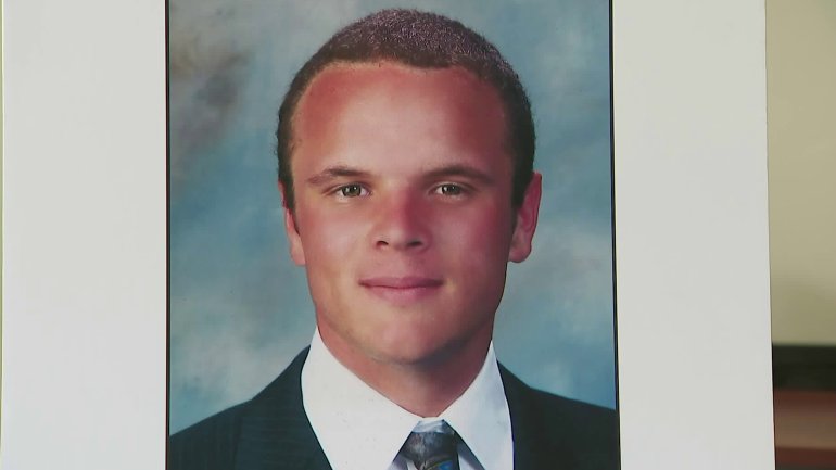 A photo of Cole Micek was displayed at a news conference where authorities announced a reward for information leading to the arrest of two hit-and-run drivers who fatally struck him on March 3, 2018. (Credit: KTLA)