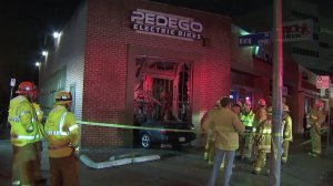 Emergency crews respond to a vehicle that crashed through a wall in North Hollywood on March 23, 2018. (Credit: KTLA)