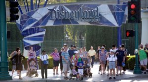Disneyland patrons exit the park under the Disneyland sign at a shuttle area in Anaheim in 2017. (Credit: Allen J. Schaben / Los Angeles Times)