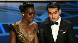 Kenyan-Mexican actress Lupita Nyong'o and Pakistani-American stand-up comedian Kumail Nanjiani present the  Oscar for Best Production Design during the 90th Annual Academy Awards show on March 4, 2018 in Hollywood. (Credit: MARK RALSTON/AFP/Getty Images)