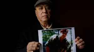 Miguel Perez poses as he holds a photo of his son Miguel Perez Jr., on April 4, 2017 in Chicago, Illinois. (Credit: JOSHUA LOTT/AFP/Getty Images)