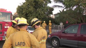 Los Angeles firefighters are shown at the scene of a fatal fire in Wilmington on March 18, 2018. (Credit: KTLA)