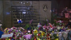 Hundreds of flowers adorn the wall outside the Pomona police headquarters where Officer Gregg Casillas' name will be inscribed among other fallen officers, March 10, 2018. (Credit: KTLA)