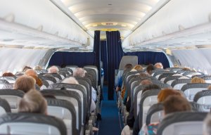 Commercial aircraft cabin with passengers. (Credit: iStock / Getty Images Plus)