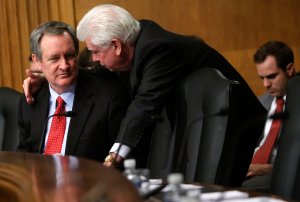 Sen. Christopher Dodd, D-CT, right, talks to Sen. Mike Crapo, R-ID, during a hearing before the Senate Banking, Housing and Urban Affairs Committee on Capitol Hill on Feb. 4, 2009 in Washington, D.C. (Credit: Alex Wong/Getty Images)