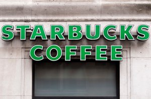 A logo is pictured above a Starbucks coffee shop in this file photo. (Credit: JUSTIN TALLIS/AFP/Getty Images)