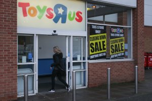 A customer walks inside a Toys 'R' Us store with 'closing down sale' signs in the windows in south London on February 9, 2018. (Credit: DANIEL LEAL-OLIVAS/AFP/Getty Images)