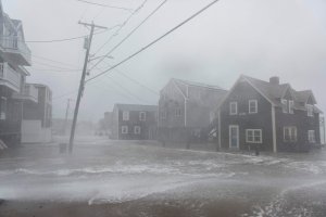 Coastal areas in New England are bracing for the high tide that is scheduled to be at its highest as waves crash into homes in Scituate, Massachusetts on March 2, 2018. (Credit: RYAN MCBRIDE/AFP/Getty Images)