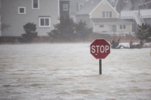 A flooded out road with a stop sign as a large coastal storm bears down on the region on March 2, 2018 in Scituate, Massachusetts. (Credit: Scott Eisen/Getty Images)