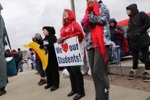 West Virginia teachers, students and supporters hold signs on a Morgantown street as they continue their strike on March 2, 2018, in Morgantown, West Virginia. (Credit: Spencer Platt/Getty Images)