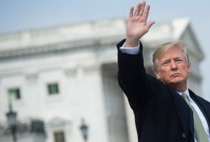 President Donald Trump waves after the annual Friends of Ireland luncheon on Capitol Hill, March 15, 2018. (Credit: Saul Loeb / AFP / Getty Images)