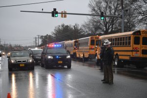 School buses, security and State Troopers are seen on March 20, 2018 at Great Mills High School in Great Mills, Maryland after a shooting at the school. (Credit: JIM WATSON/AFP/Getty Images)