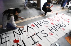 Young activists paint signs to be carried at the upcoming March for Our Lives Los Angeles on March 22, 2018 in Los Angeles, California. (Credit: Mario Tama/Getty Images)