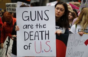 Activists hold signs during the March for Our Lives rally in Los Angeles on March 24, 2018. (Credit: Mario Tama/Getty Images)