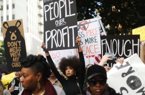 Protesters hold signs during the March for Our Lives rally on March 24, 2018 in Los Angeles. (Credit: Mario Tama/Getty Images)